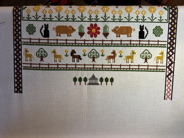 Cross stitch sampler with ever growing decorative borders. 