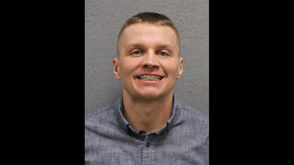 mug shot. white male with short hair and braces sporting a big Irish smile.