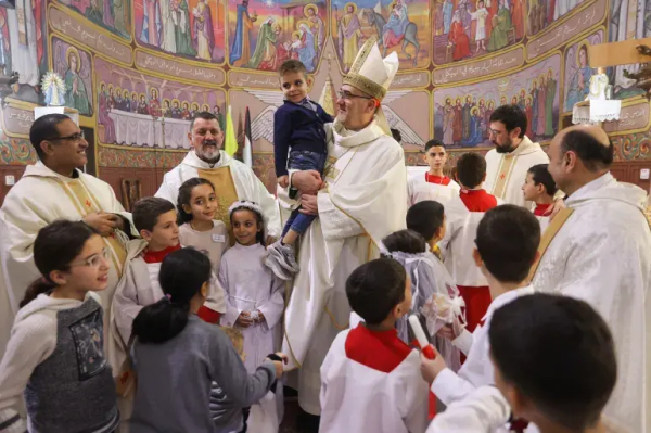 Latin Patriarch of Jerusalem Pierbattista Pizzaballa held a pre-Christmas mass at the Holy Family Church in Gaza City on Sunday, as Israeli forces flew drones overhead [Omar Al-Qattaa/AFP]