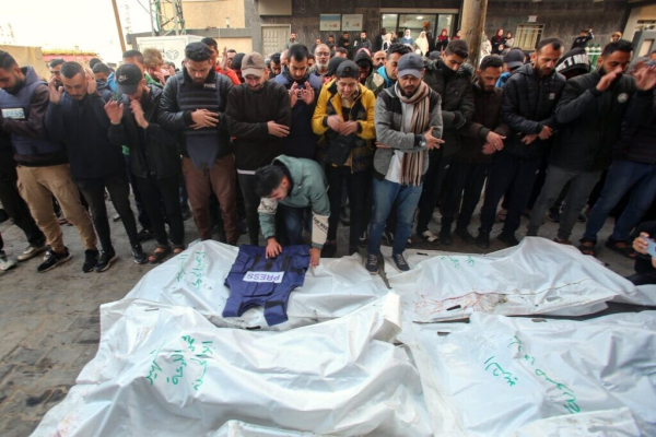 Mourners attend the funeral of members of the press who were killed in an Israeli strike, at the al-Awda Hospital in the Nuseirat refugee camp in the central Gaza Strip, on December 26, 2024.