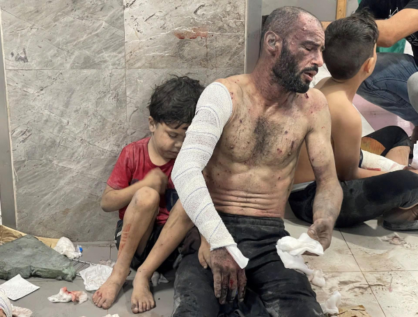 Wounded father with his young son in hospital corridor.