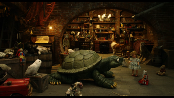 An subterranean scene with toys and animals and a giant turtle in the middle.