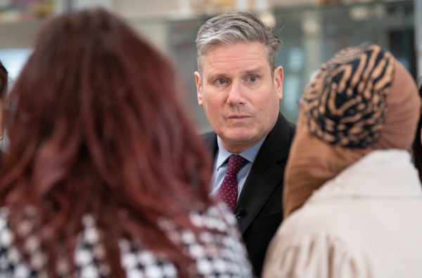 Phot: Starmer talking to two women with their backs turned, caption says  Sir Keir Starmer meets representatives from organisations dedicated to supporting victims of violence against women and girls (VAWG) in 2023.