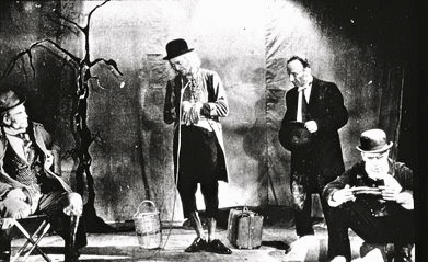 A picture from the first production of the play. Godot, in the original production, was played by Jules Berry.