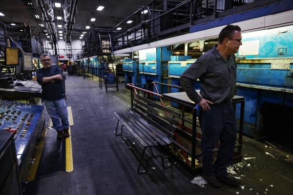 Pressmen David Illick, left, and John Anthony, of St. Louis, watch as the final locally printed copies of the St. Louis Post-Dispatch newspaper are fed through the printing press on Sunday, Jan. 5, 2025, at the Pulitzer Publishing Center in Maryland Heights. Photo by Zachary Linhares, Post-Dispatch