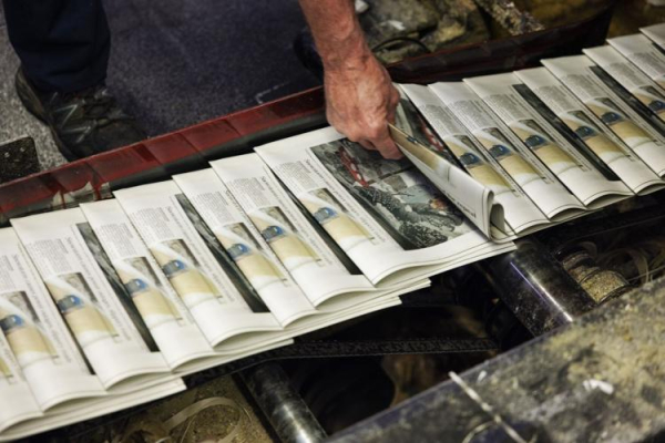 Matt Deters picks up a copy of the St. Louis Post-Dispatch to check the print quality as the final locally printed edition comes off the press. Photo by Zachary Linhares, Post-Dispatch