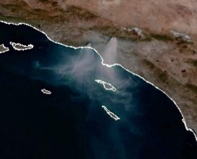 Screen shot of NWS satellite photo showing Los Angeles area coast, with plumes of smoke blowing from the Palisades fire and the Eaton fire blowing north-to-south over the Pacific Ocean.