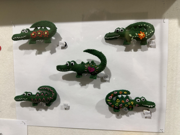 Pinned within a display case, the Quirky Crocodile series of brooches by Tamara Salajic.