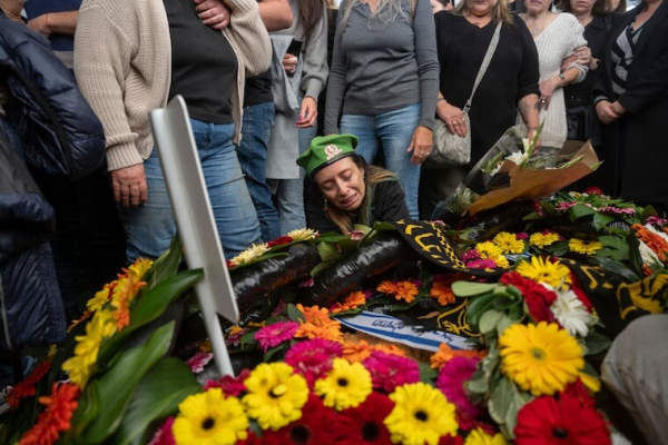 Gali the mother of the Israeli soldier Sergeant Yahav Maayan who was killed in combat in the Gaza Strip, reacts next to his son's grave during his funeral at a military cemetery in Modiin, Israel, Sunday, Jan. 12, 2025.