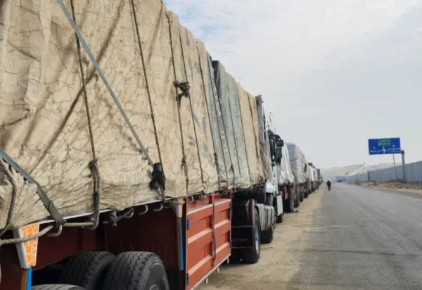 Trucks carrying aid line up near the Rafah crossing on January 16, 2025, waiting to make deliveries into Gaza after the announcement of the ceasefire between Israel and Hamas [Reuters]
