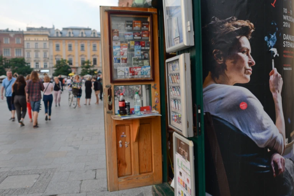 Photo: A poster of a Woman smoking sits on the sidde of a kiosk in a public square in Krakow, Caption: A tobacconist kiosk in Krakow, Poland, where researchers and anti-smoking campaigners were labelled ‘militant extremists’.Credit: Artur Widak/NurPhoto/Getty