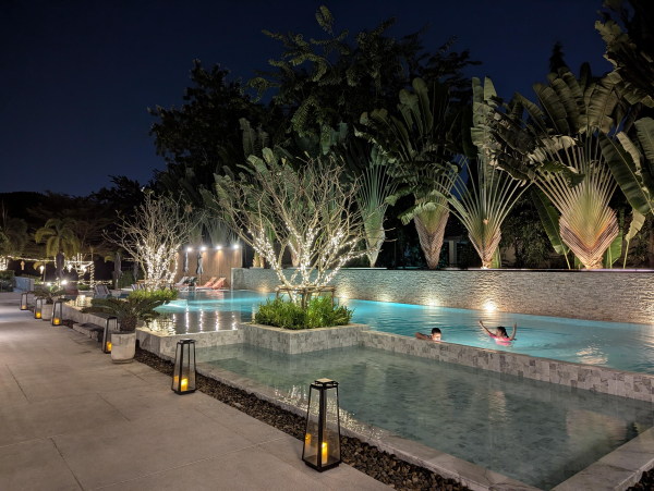 Photo of a hotel swimming pool and garden.