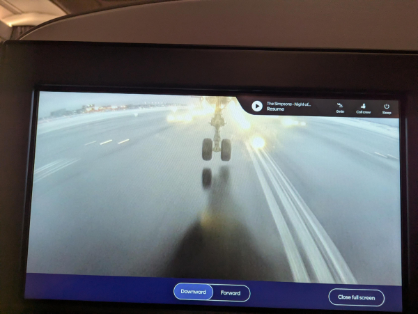 Photo of the external camera view displayed inside a Finnair A350 landing at Helsinki. The front landing gear can be seen just above the runway surface.