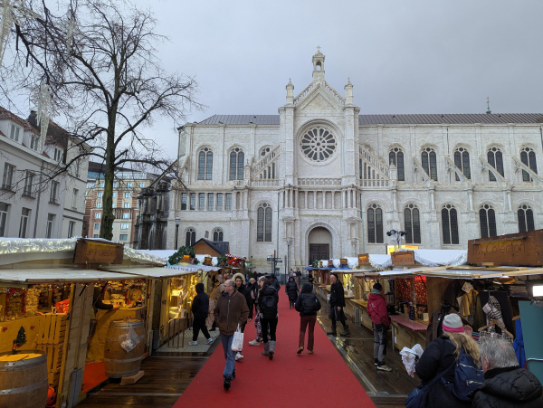 Photo of the Christmas markets in Brussels, with a large white church in the background.