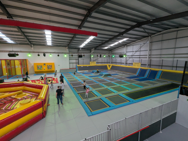 Photo of the trampoline area of an indoor play centre.