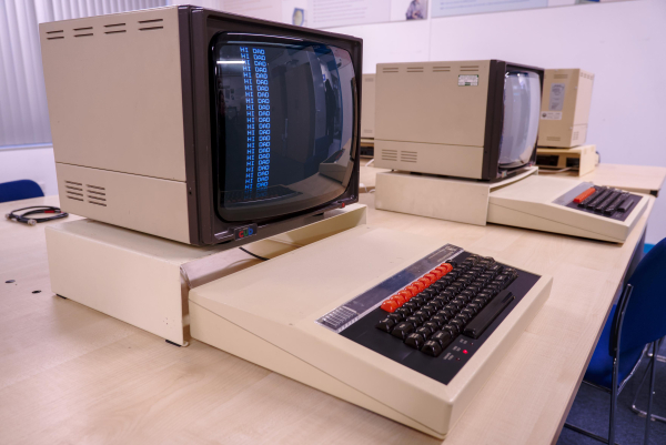 Photo of two BBC microcomputers lined up on a long table.