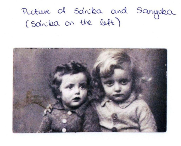 Old photograph of two young children, sitting side by side.