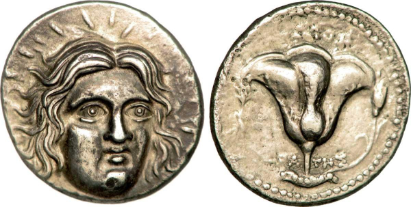 Photograph of both the obverse and the reverse of a silver tetradrachm coin. On the obverse is the head of Helios, his face turning slightly to the right, sun beams radiating from his head.
On the reverse we see a rose on a stem with a bud growing to the right.