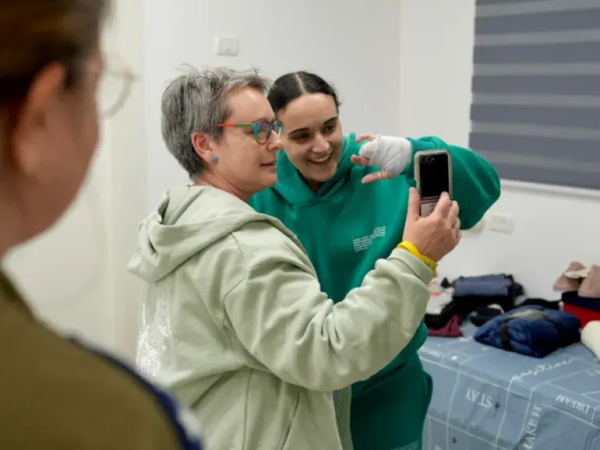 Released British-Israeli captive Emily Damari uses a phone with her mother, Mandy, after being held in Gaza on January 19, 2025 [Israeli military via Reuters]