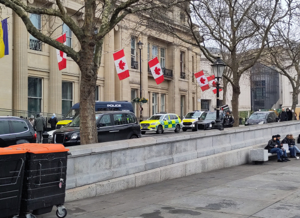 Two police vans and a car on Trafalgar square