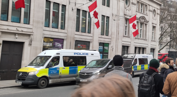 Two of three police vans parked outside Canada house