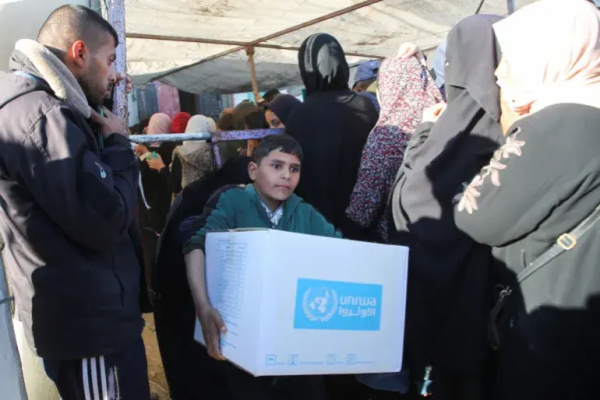 “Most of them are traumatised. Most of them are sick.”

“Gaza deserves full opening up for humanitarian and development recovery aid, not just humanitarian aid.”
 
A Palestinian boy carries an aid box provided by the UNRWA in Khan Younis in southern Gaza, on January 21, 2025 [Hatem Khaled/Reuters]

