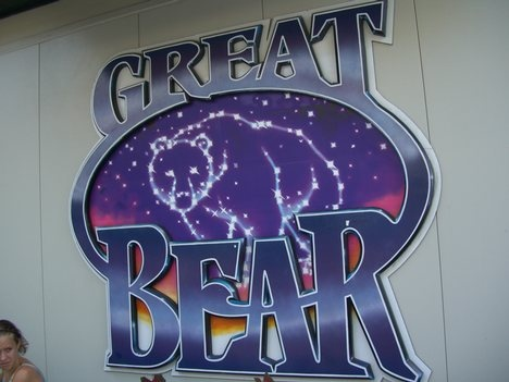 Photograph of the Great Bear rollercoaster sign from Hersheypark. The Text "Great Bear" is in blue and in the center of an oval is the drawing of the night sky with a bear drawn in as a constellation. 