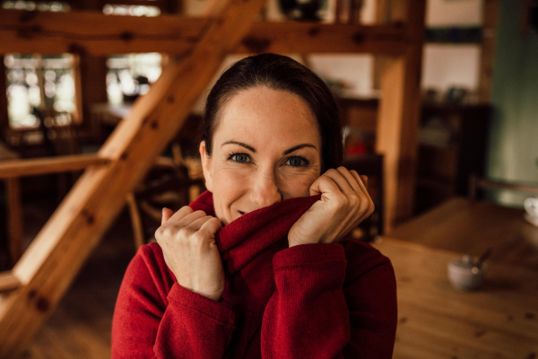 Portrait with red Hoodie in a timber-framed House 