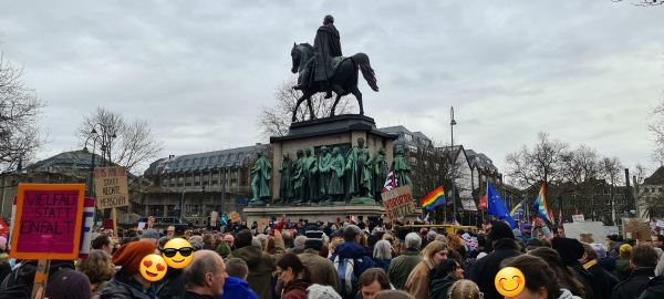 Reiterstandbild auf dem Heumarkt. Davor viele Menschen mit Fahnen und Transparenten gegen rechts