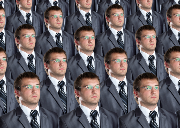 What at first glance looks like rows of men in suits is actually one man in a suit who has been replicated again and again like a clone. The many copies of the one man have short dark hair and are identically dressed in a grey suit, white shirt and tie with black and grey diagonal stripes. They all stare rigidly into the distance through metal-framed spectacles. The overall effect is disturbing and creepy.