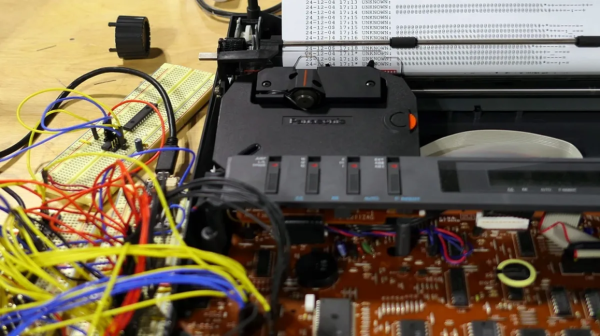 [ImageSource: mrchristyengineering]

What makes Sam’s hack particularly exciting is its adaptability. By effectively replacing the original keyboard with an ESP32 microcontroller, he designed the setup to work with almost any electric typewriter. The project involves I2C communication, multiplexer circuits and SMS management via Twilio. The paper feed uses an “infinite” roll of typing paper — something Sam humorously notes as outlasting magnetic tape for storage longevity.