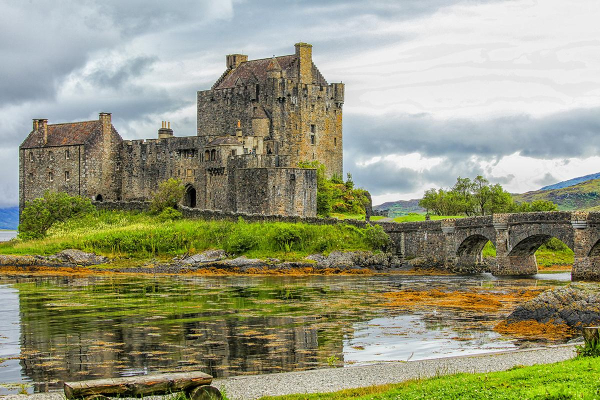 Eilean Donan Castle in the Highlands of Scotland

The castle was founded in the thirteenth century, and became a stronghold of the Clan Mackenzie and their allies the Clan MacRae. In the early eighteenth century, the Mackenzies' involvement in the Jacobite rebellions led in 1719 to the castle's destruction by government ships. Lieutenant-Colonel John Macrae-Gilstrap's twentieth-century reconstruction of the ruins produced the present buildings.