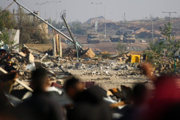 Israeli, military, watches, Palestinians, at, Gaza, crossing