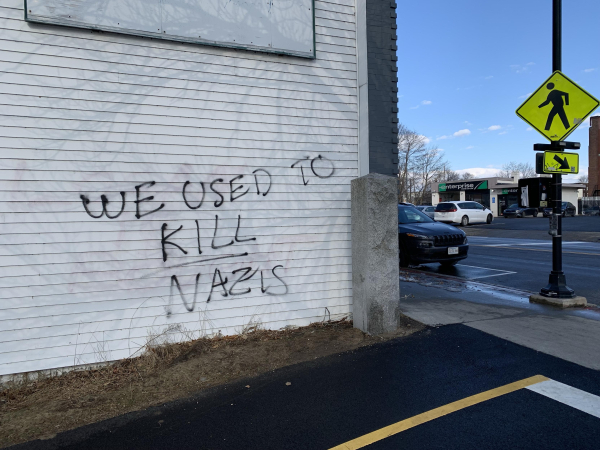 Graffiti on wall of commercial building reads: “we used to kill nazis”