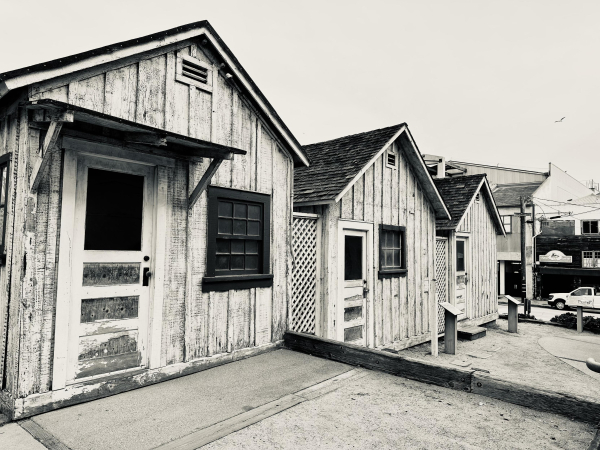 A black and white ish digital photo of some old huts near cannery row 