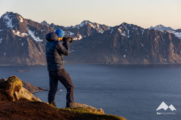 man with a camera taking a photo of the beautiful landscape on the Lofoten Islands.