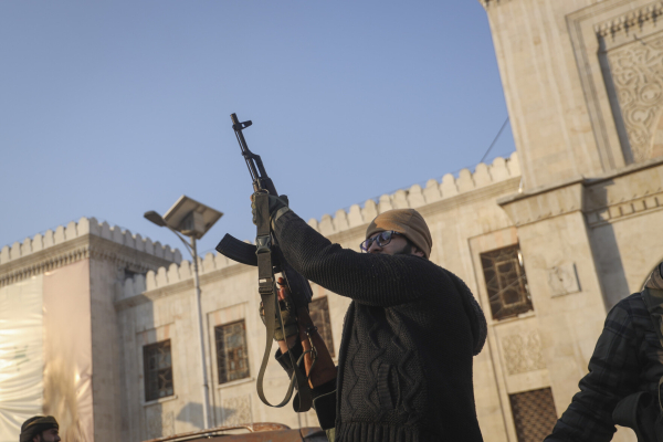 An opposition fighter fires his AK-47