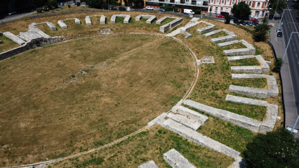 View of the Budapest Roman Military amphitheatre from above, nested between buildings and the main road