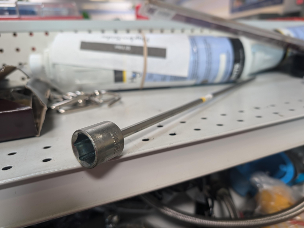 19mm socket with a very long hex shaft permanently attached sits, forlorn, on a thrift store shelf.