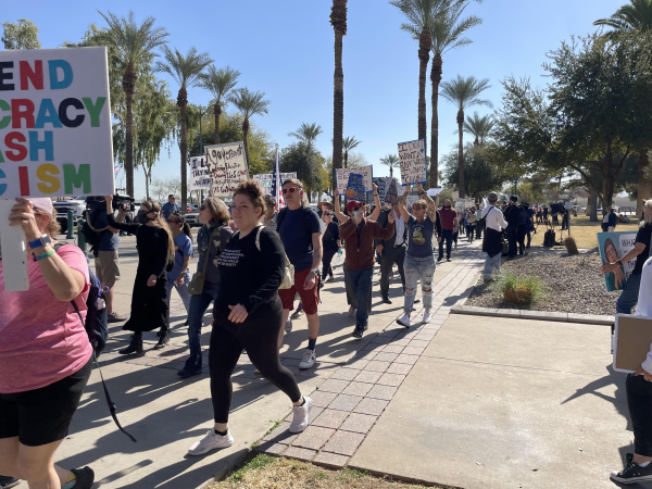 Protestors walking with signs. 