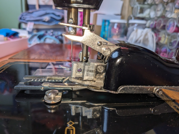 Difficult to make out but it's the parts of the buttonholer which attach to the sewing machine, lined up so that you can sort of see where things go