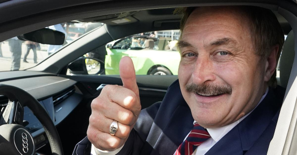 Mike Lindell gives a thumbs up as he passes by a rally for supporters of former President Donald Trump, Tuesday, April 4, 2023, in West Palm Beach, Fla. (AP Photo/Wilfredo Lee).