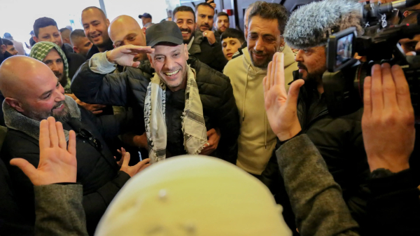 People escort a released prisoner through a large crowd in Ramallah, West Bank on February 8, 2025. (Photo by MOSAB SHAWER/Middle East Images/AFP via Getty Images)