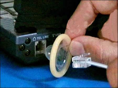 a phone line being plugged through a condom  into a modem 