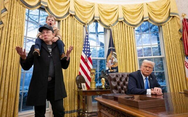 Tesla and SpaceX CEO Elon Musk with his son X Æ A-Xii join US President Donald Trump as he signs executive orders in the Oval Office of the White House in Washington, February 11, 2025. (Photo by Jim WATSON / AFP)