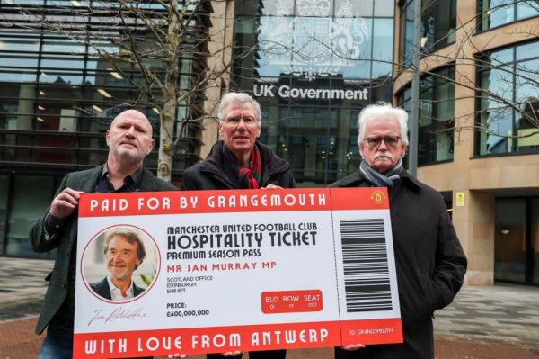 Photo: Holding up a season ticket for Mancher United, title 'paid for by Grangemouth'