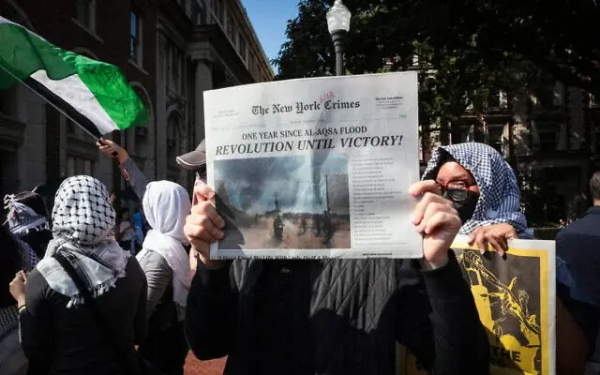 Pro-Palestinian, anti-Israel demonstrators march through the Columbia University campus in New York City to mark a year since the Hamas terror group's onslaught on southern Israel that sparked the ongoing war in Gaza, October 7, 2024. (Kena Betancur/AFP)