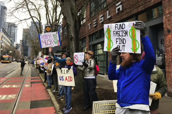  Protesters demonstrate in front of a Tesla showroom in Seattle’s South Lake Union neighborhood on Saturday to voice opposition to Tesla CEO Elon Musk’s newfound power as an unelected “special government employee.” (Brendan Kiley / The Seattle Times)