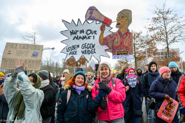 Zwei Frauen mit Schild: „Not in our name! Lesben gegen Alice Weidel“. Daneben „Fuck eachother not the world“, „Du bist nicht allein“ mit Extinction Rebellion-Logo und „Wir haben die Wahl“. Beim Klimastreik von Fridays for Future vor der Bundestagswahl 2025, Wilhelmstraße, Berlin, 14.02.2025