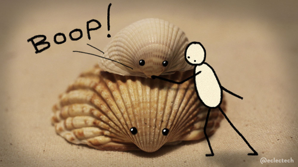 A photo of two cockle shells, one larger and darker, the other smaller and lighter sitting on top of it, against a cream canvas backdrop. They both have eyes drawn on. A simple drawn figure leans in from the right to boop the small one on its snout. The word BOOP! is scribbled in the top left.